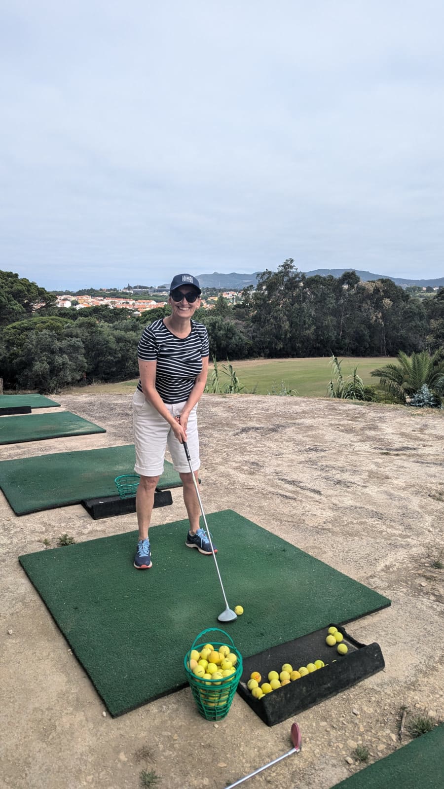 Sara taking a swing on a golf driving range